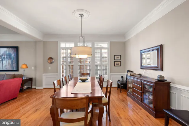 a view of a hallway with wooden floor and windows