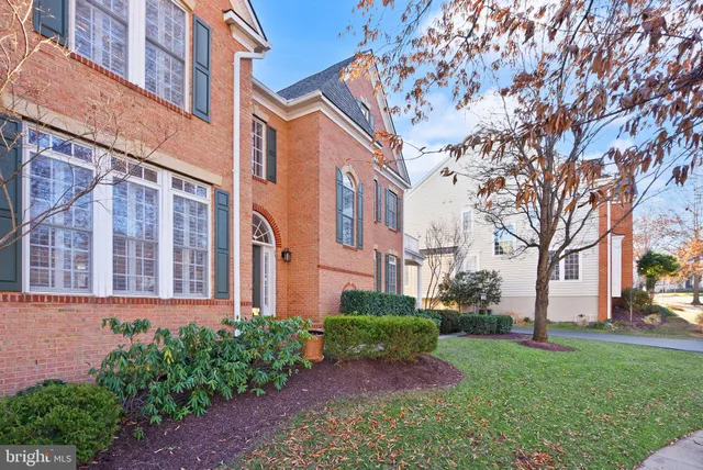 a view of a dining room with furniture a chandelier and wooden floor