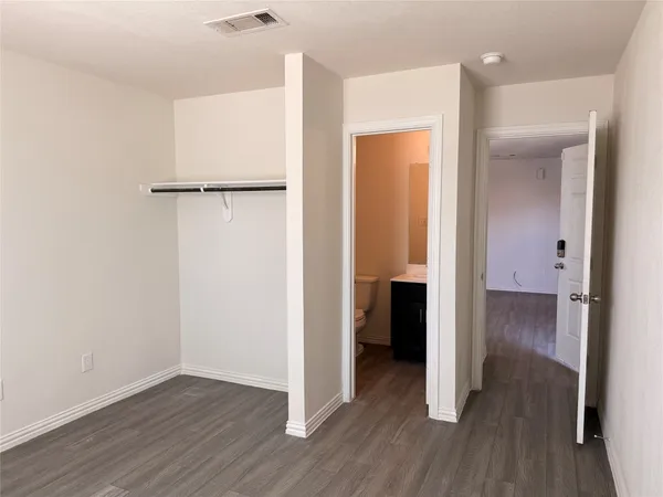 a view of hallway with wooden floor
