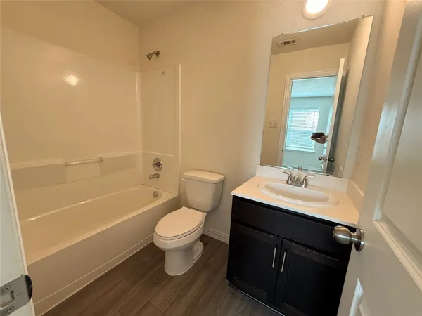 a bathroom with a sink toilet a mirror and shower