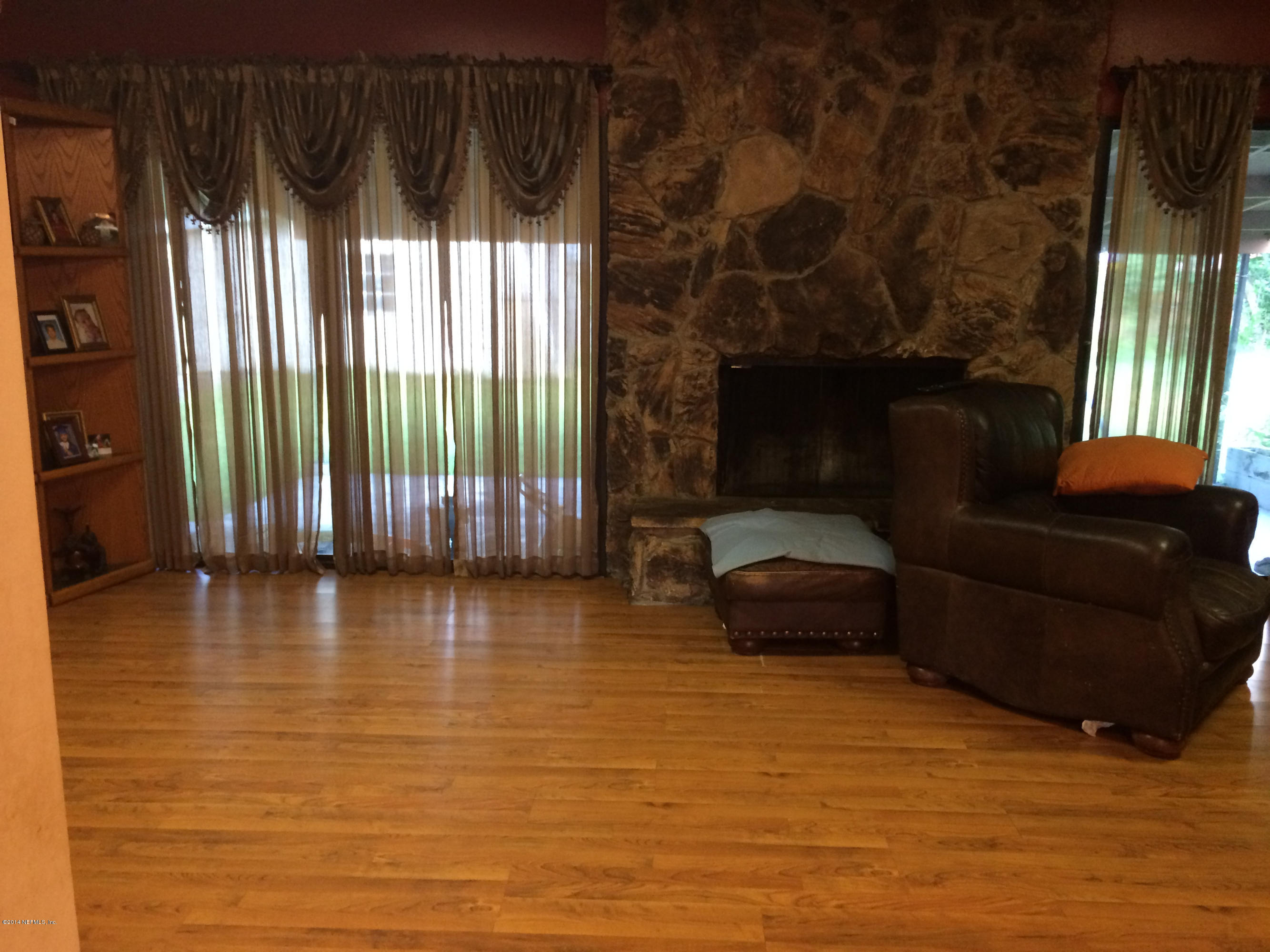 2433 Sam Road Jacksonville, FL 32216 - Photo 11 of 22 a living room with furniture and a fireplace