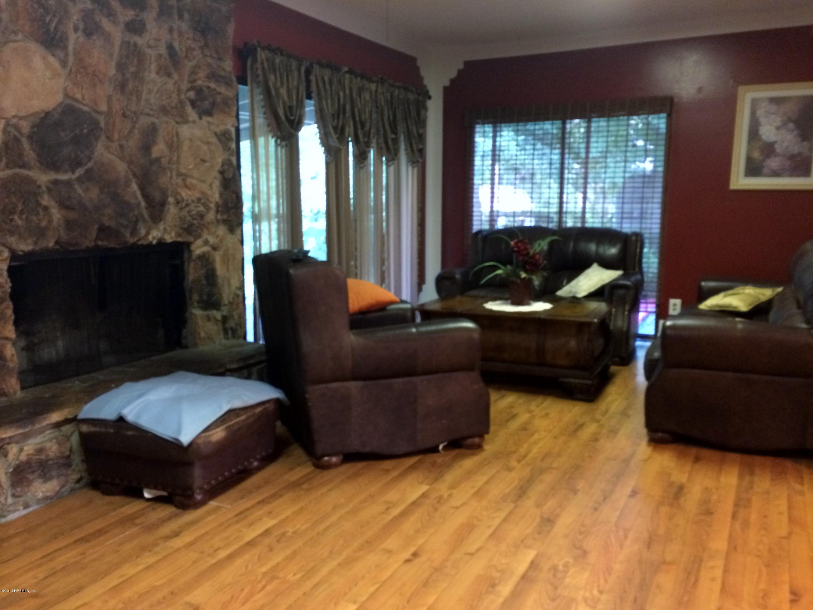 2433 Sam Road Jacksonville, FL 32216 - Photo 12 of 22 a living room with furniture and a fireplace