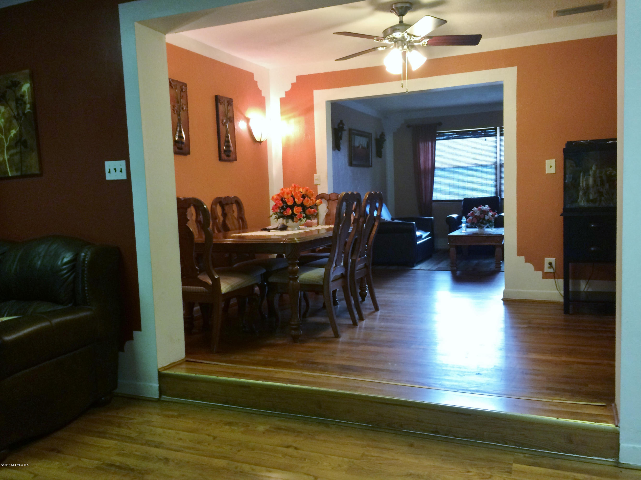2433 Sam Road Jacksonville, FL 32216 - Photo 13 of 22 a view of a livingroom with furniture a dinning room and stairs