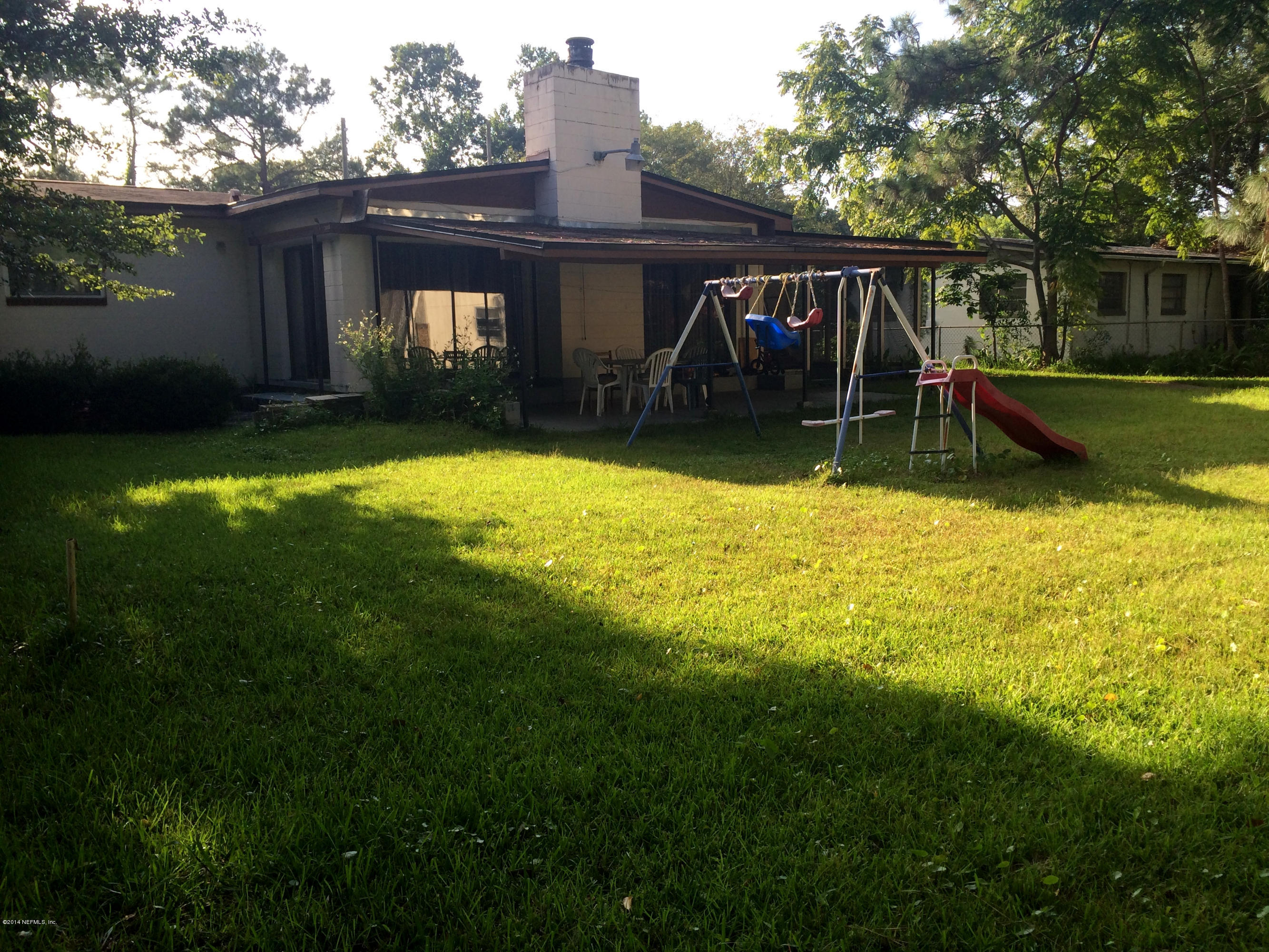 2433 Sam Road Jacksonville, FL 32216 - Photo 21 of 22 a view of a house with backyard and porch