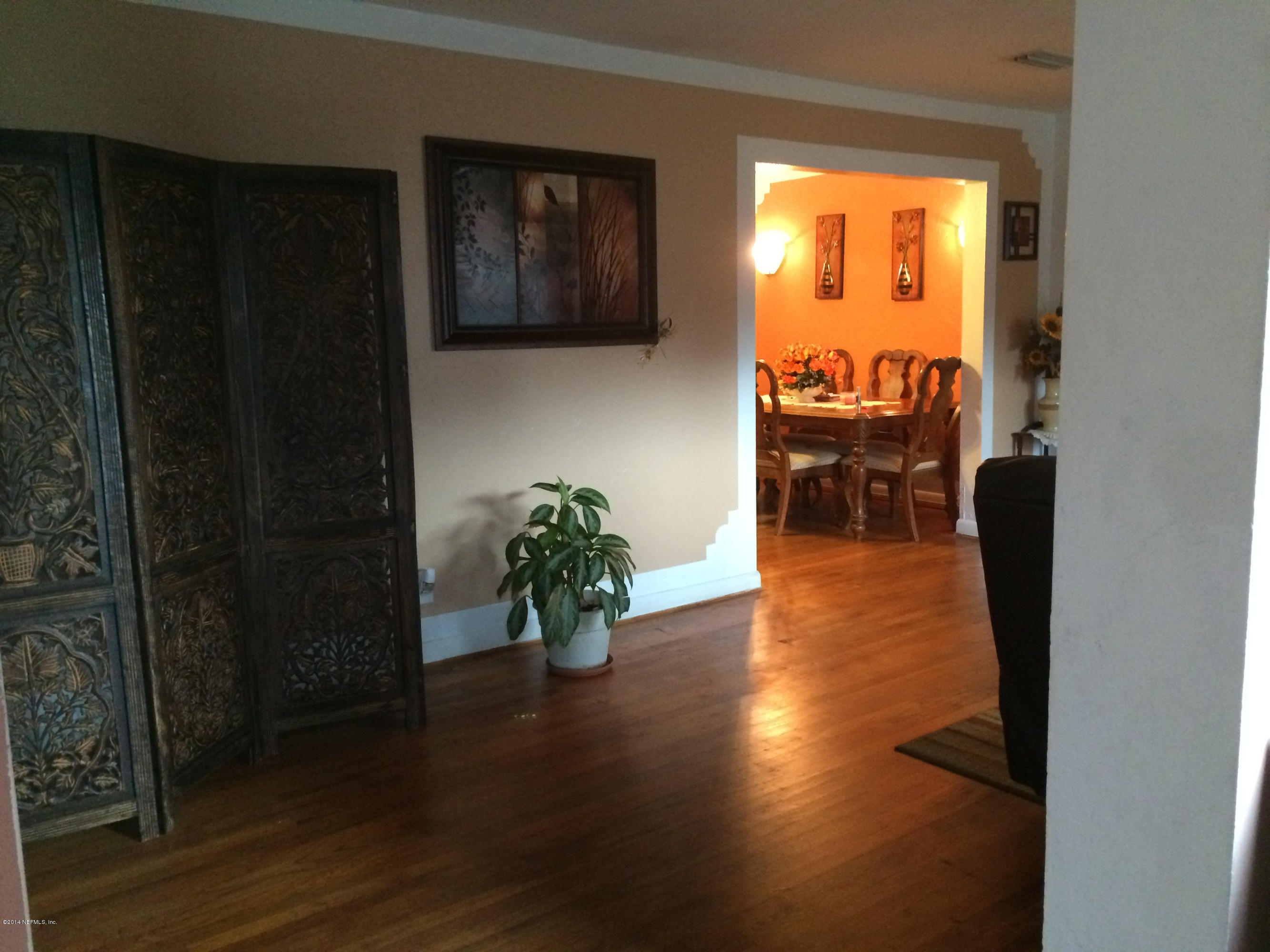 2433 Sam Road Jacksonville, FL 32216 - Photo 3 of 22 a living room with furniture and a floor to ceiling window