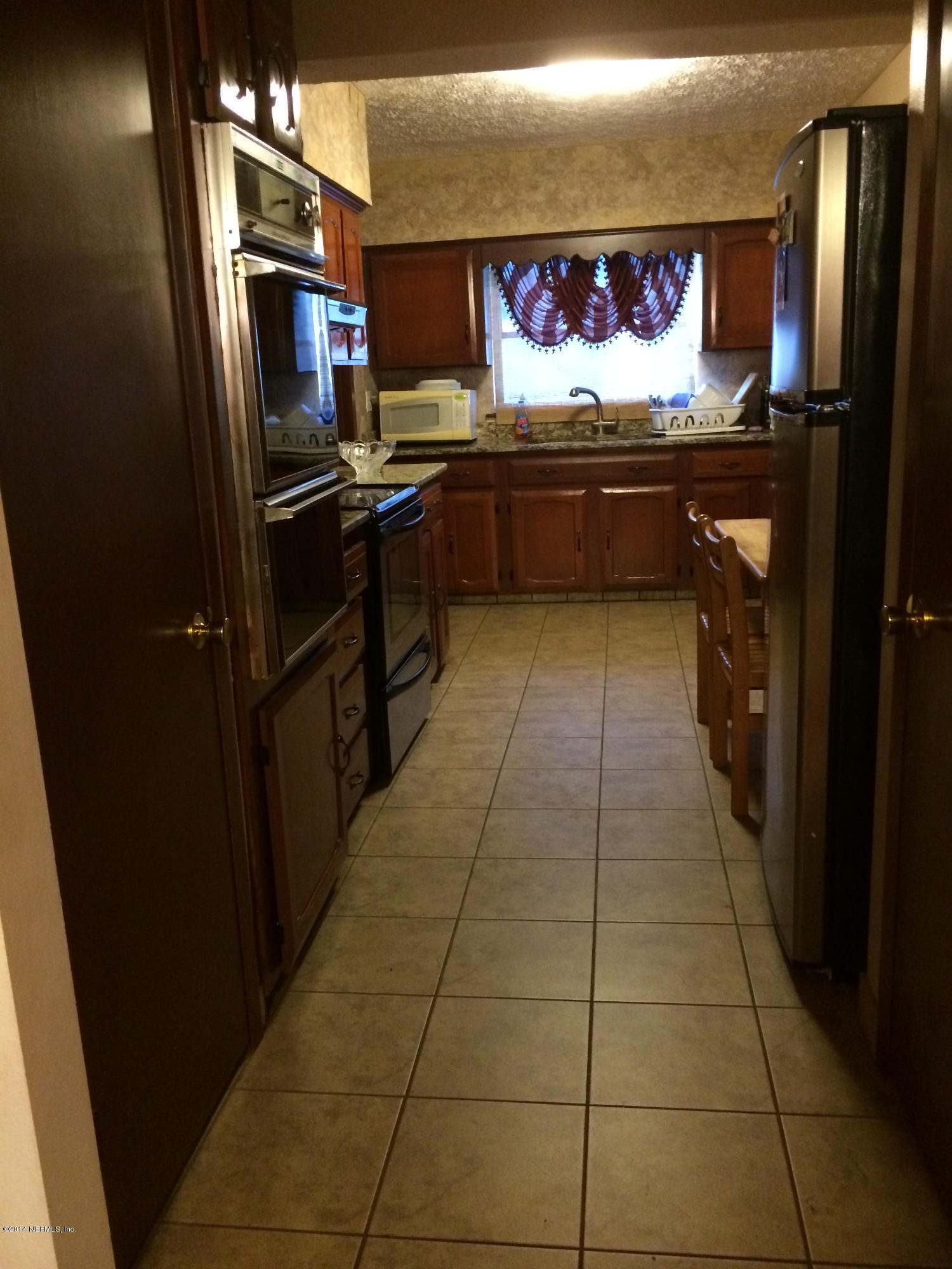 2433 Sam Road Jacksonville, FL 32216 - Photo 6 of 22 a kitchen with stainless steel appliances granite countertop a refrigerator and a sink