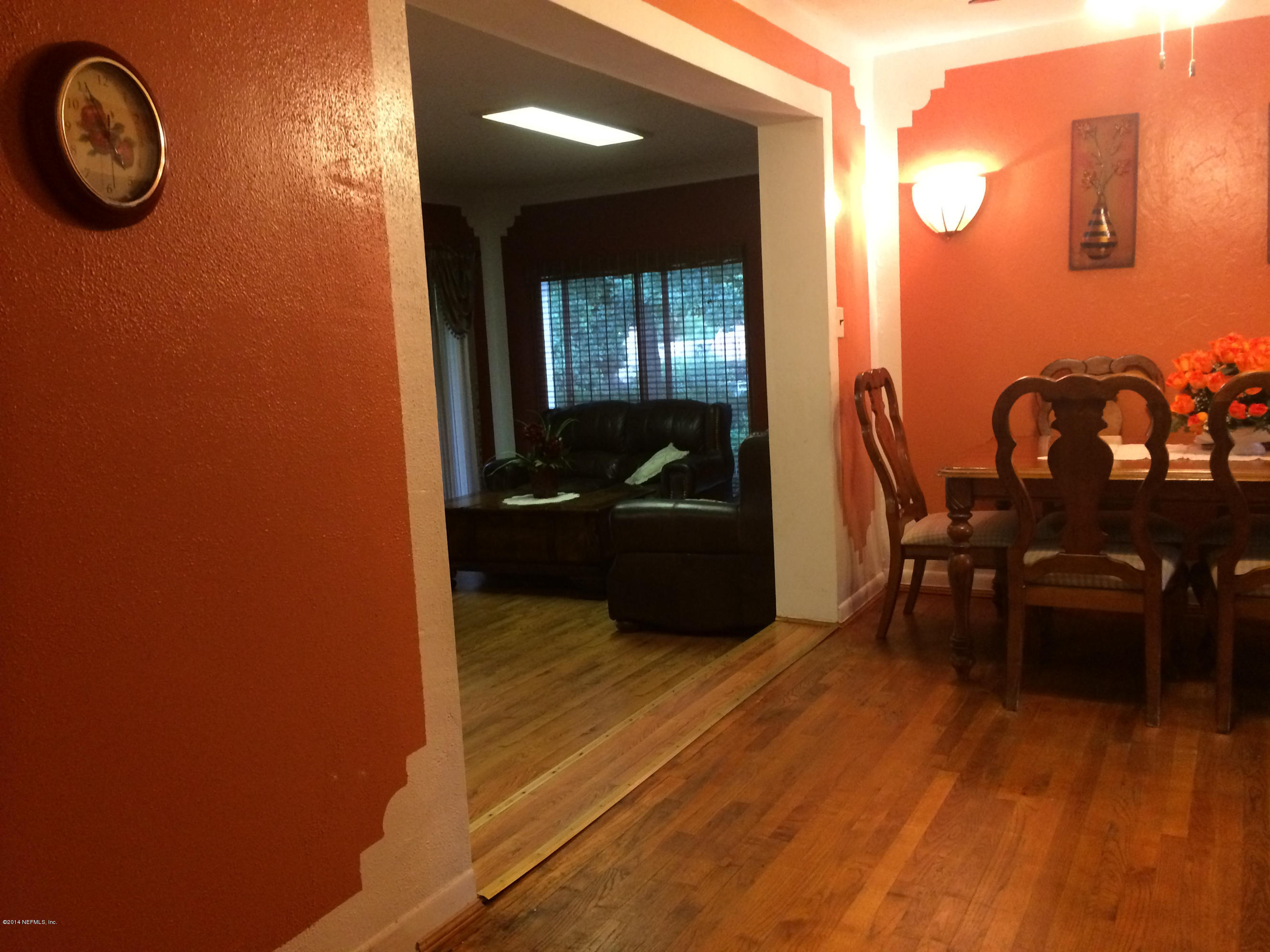 2433 Sam Road Jacksonville, FL 32216 - Photo 10 of 22 a view of a livingroom with furniture a dinning area wooden floor and front door