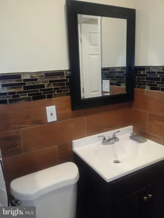 a bathroom with a sink a toilet and mirror