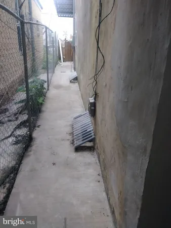 a view of a pathway of a house with wooden fence