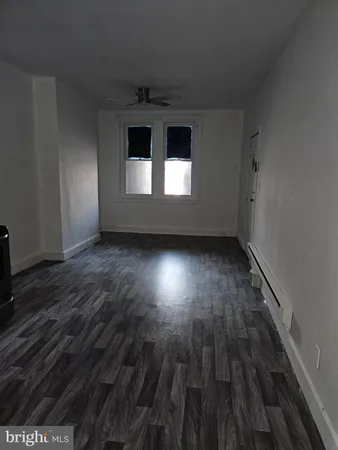 a view of wooden floor and windows in a room