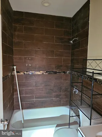 a white toilet sitting next to a bathroom sink