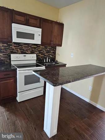 a stove top oven sitting inside of a kitchen