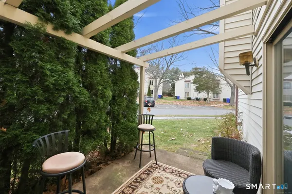 a view of a porch with furniture and a yard
