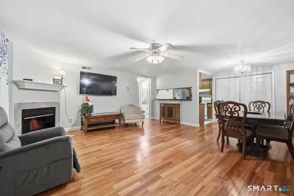 a living room with furniture a fireplace and a flat screen tv