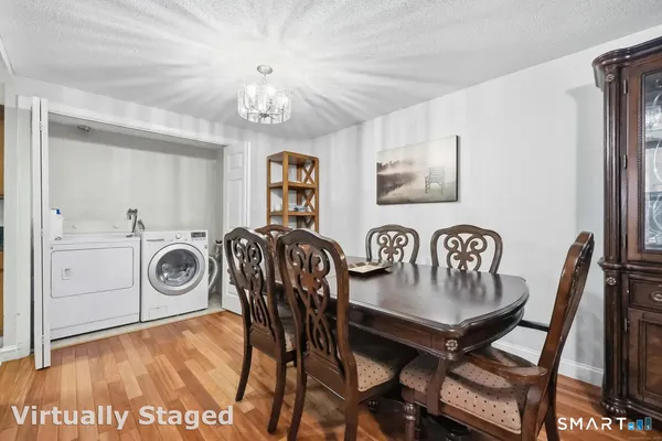 a view of a dining room with furniture and chandelier