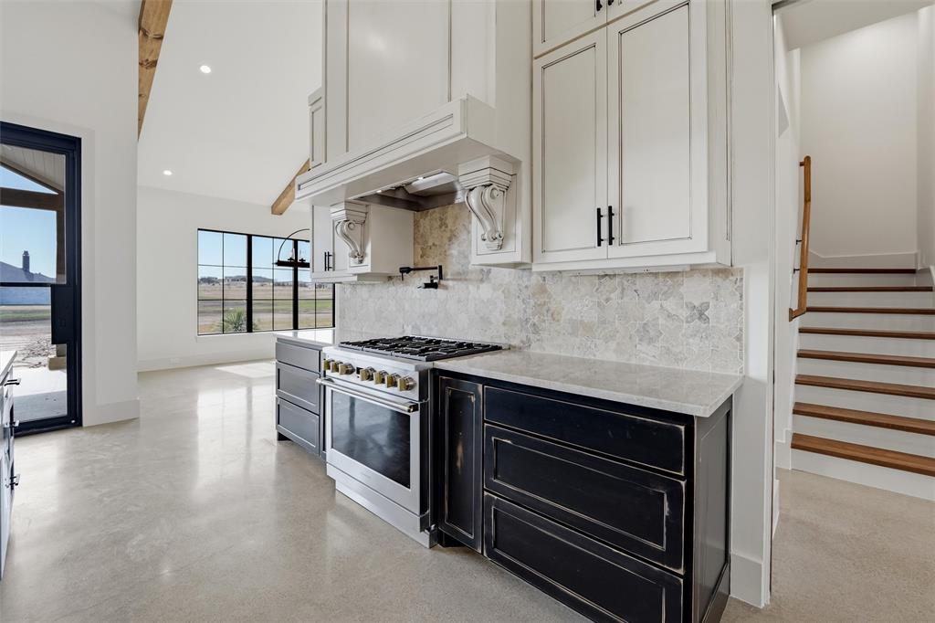 2004 Denali Pass Aledo, TX 76008 - Photo 12 of 40 a kitchen with stainless steel appliances a stove and white cabinets