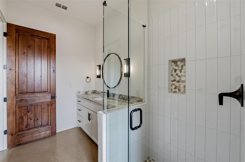 2004 Denali Pass Aledo, TX 76008 - Photo 29 of 40 a bathroom with a granite countertop sink a mirror and shower