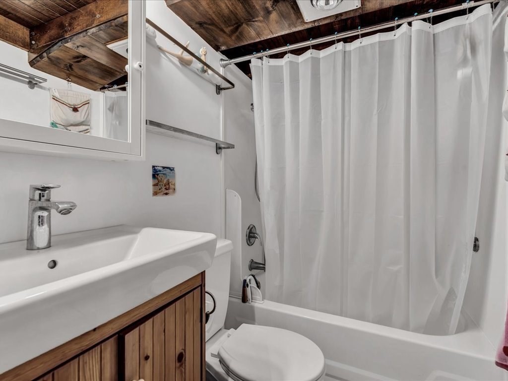 56 Ryder Street Wareham, MA 02532 - Photo 15 of 29 a bathroom with a sink a toilet and shower curtain