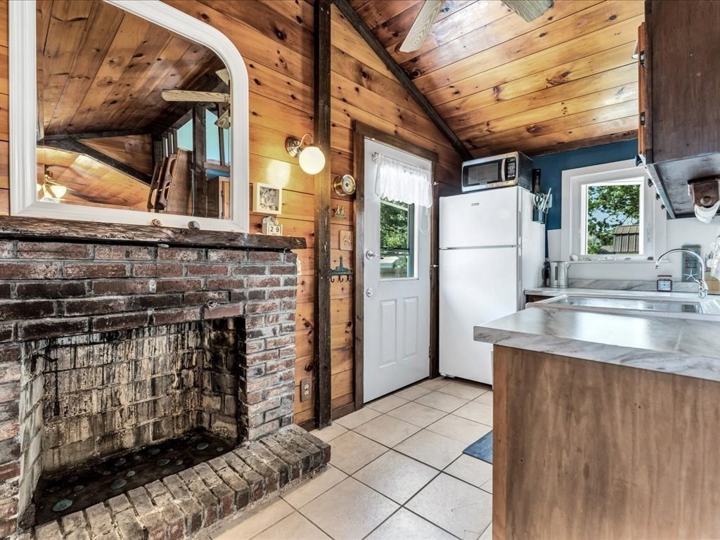 56 Ryder Street Wareham, MA 02532 - Photo 4 of 29 a kitchen with stainless steel appliances kitchen island granite countertop a refrigerator a stove and a sink with wooden floors