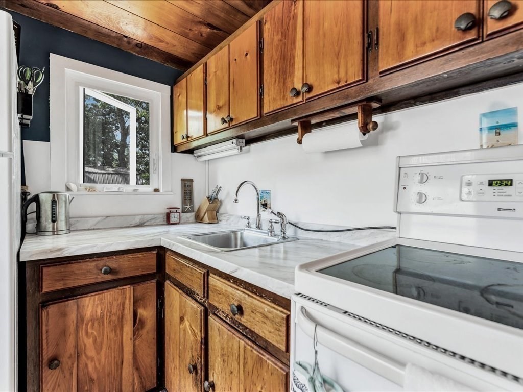 56 Ryder Street Wareham, MA 02532 - Photo 6 of 29 a kitchen with stainless steel appliances granite countertop a sink stove and cabinets