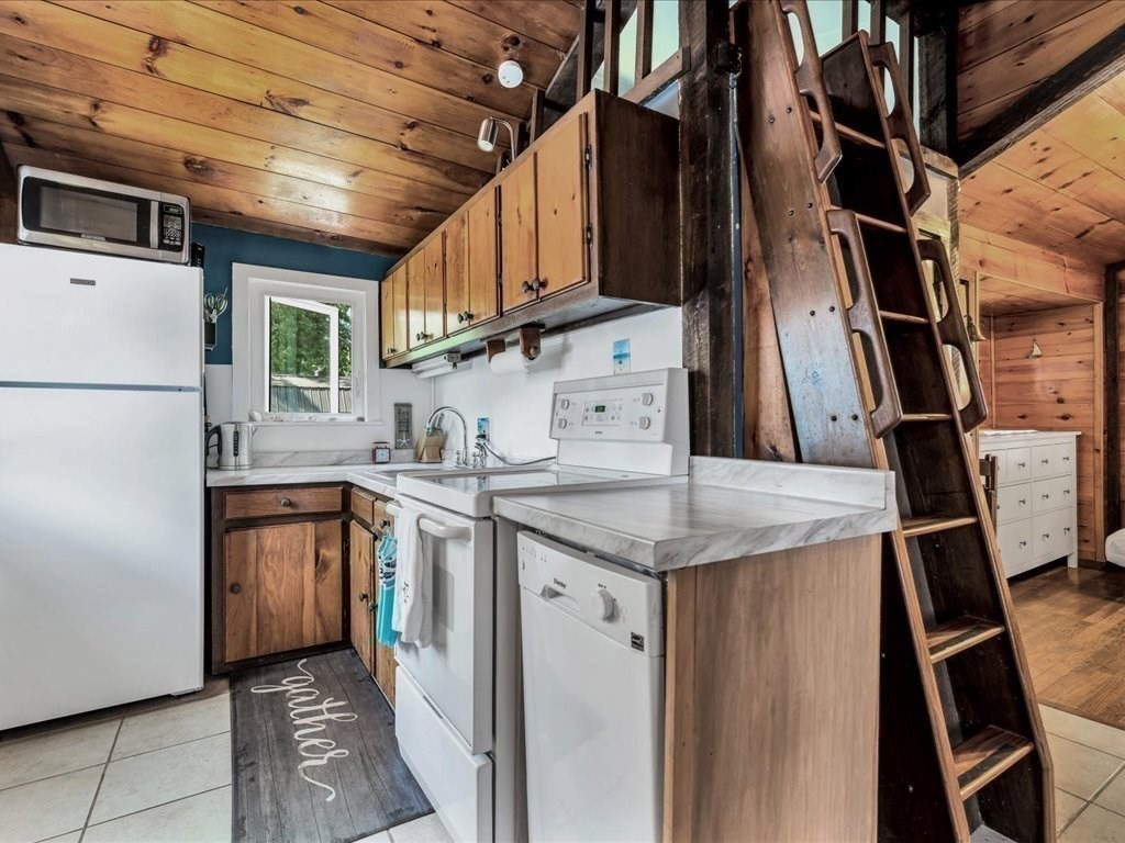 56 Ryder Street Wareham, MA 02532 - Photo 7 of 29 a kitchen with stainless steel appliances granite countertop a refrigerator a sink dishwasher a stove and white countertops with wooden floor