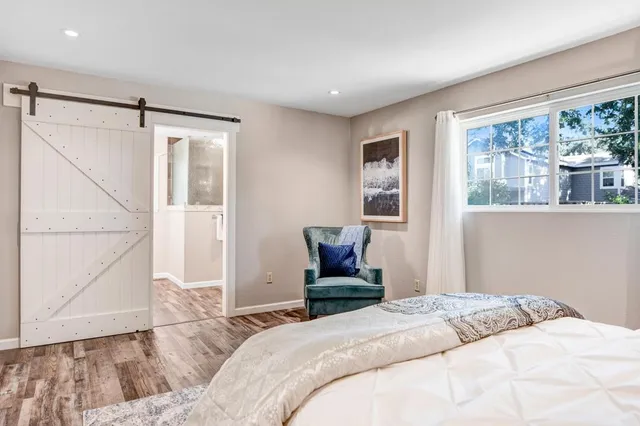 a bedroom with a bed window and couch