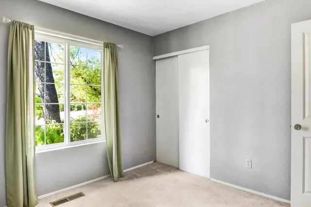 a view of an empty room with large windows