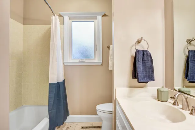 a bathroom with a sink toilet and mirror
