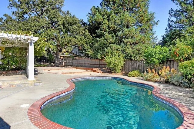 a view of a swimming pool with a patio