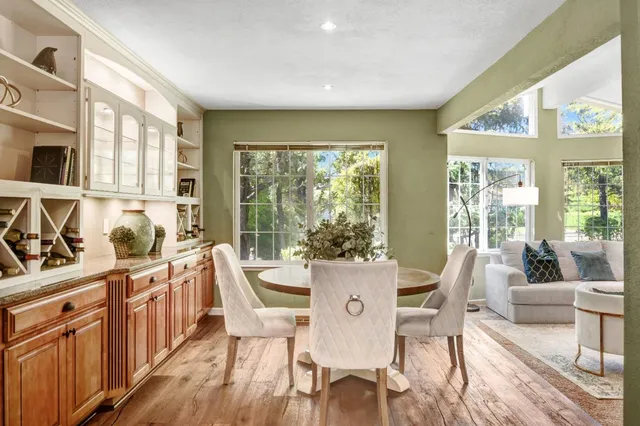 a view of a dining room with furniture a chandelier and wooden floor