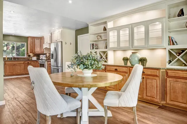 a dining room with furniture and wooden floor
