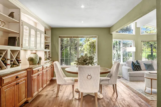 a view of a dining room with furniture a chandelier and wooden floor