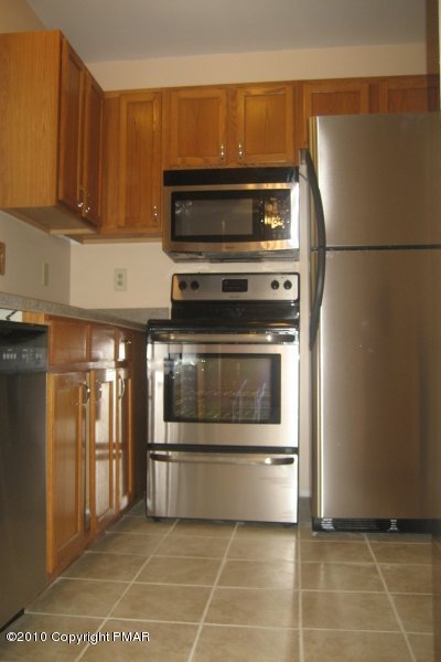 148 Little Twig Road Effort, PA 18330 - Photo 7 of 13 a kitchen with a stove and a refrigerator