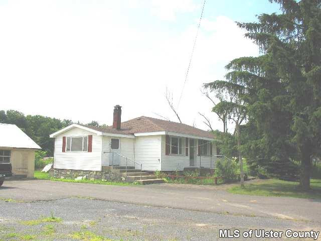 7413 Highway 32 Cairo, NY 12413 - Photo 3 of 3 a front view of a house with a yard and garage