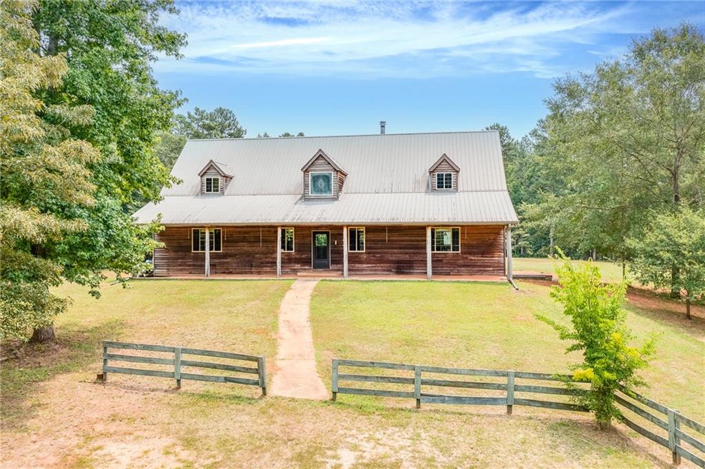 1930 Calhoun Road Dewy Rose, GA 30634 - Photo 1 of 1 a view of a house with a swimming pool
