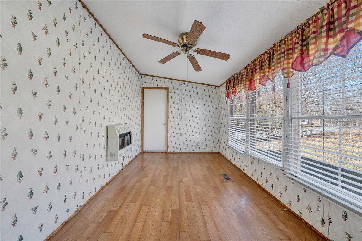 829 Moorman Mill Road Rustburg, VA 24588 - Photo 14 of 45 a view of a hallway with wooden floor and a ceiling fan