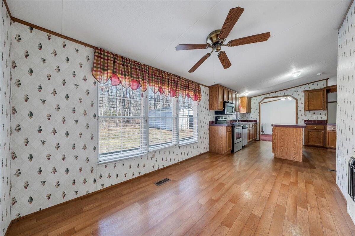 829 Moorman Mill Road Rustburg, VA 24588 - Photo 15 of 45 a living room with hard wood floors and a kitchen