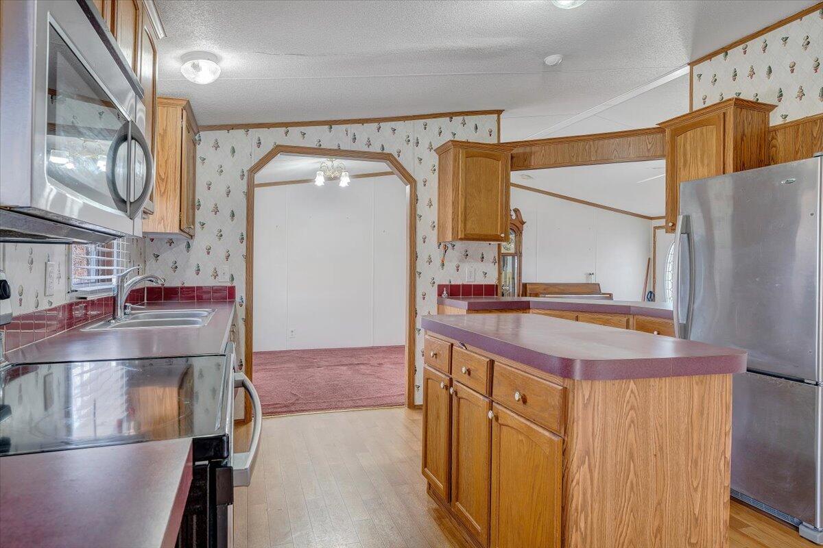 829 Moorman Mill Road Rustburg, VA 24588 - Photo 18 of 45 a kitchen with stainless steel appliances granite countertop a sink and a refrigerator