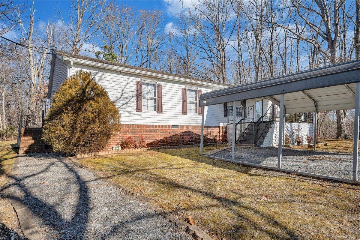 829 Moorman Mill Road Rustburg, VA 24588 - Photo 3 of 45 a view of a house with a yard and wooden fence