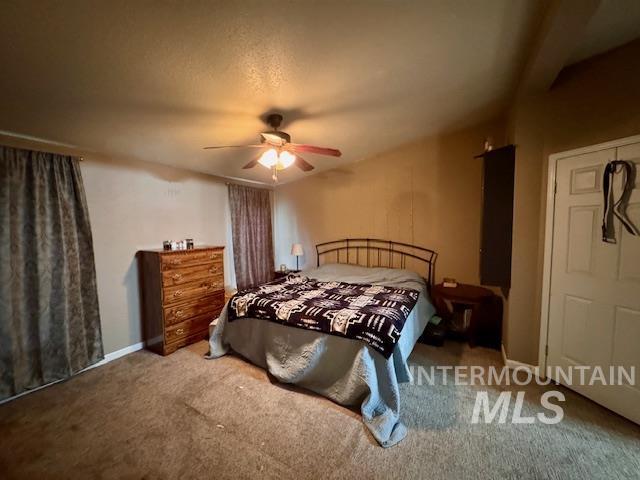 7880 Sweet Ola Highway Sweet, ID 83670 - Photo 8 of 24 Carpeted bedroom featuring a ceiling fan and a textured ceiling