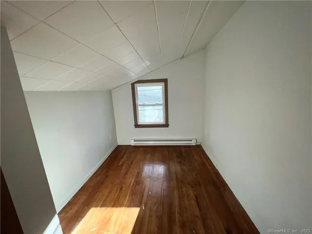 a view of an empty room and wooden floor