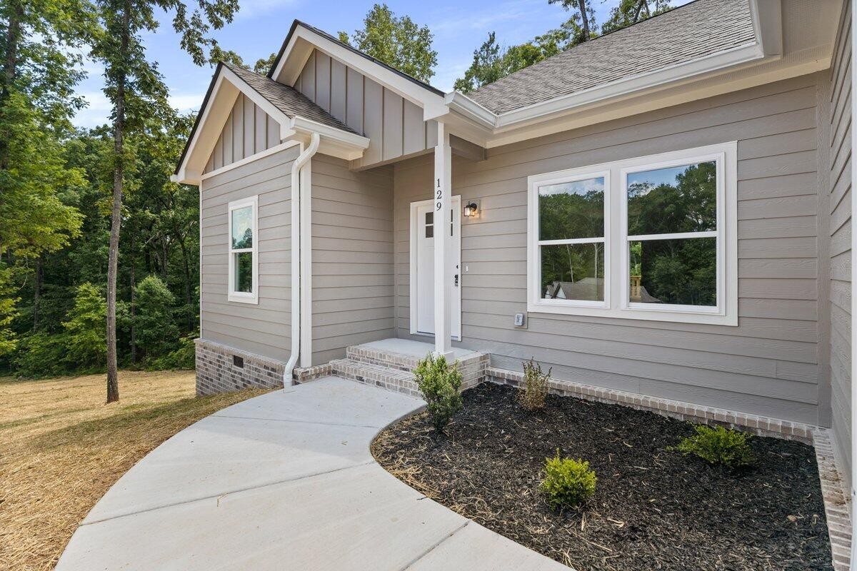 129 County Road 155 Riceville, TN 37370 - Photo 5 of 31 a front view of a house with garden