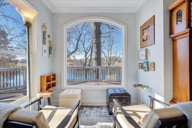 a living room with furniture and a floor to ceiling window