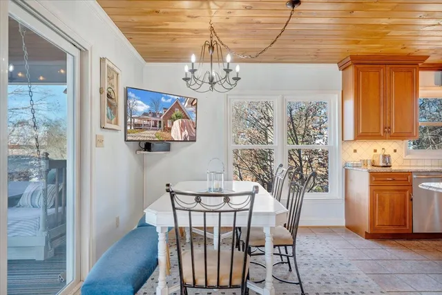 a view of a hallway with two windows and a chandelier