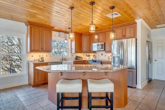 a living room with furniture a fireplace and a large window