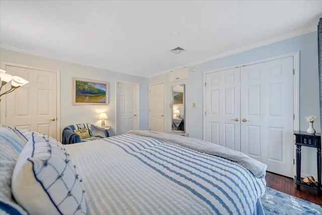 a living room with furniture a rug and a bookshelf