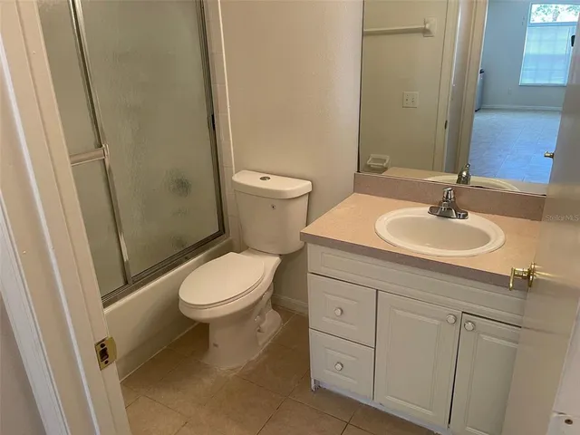 a bathroom with a toilet a sink and a mirror