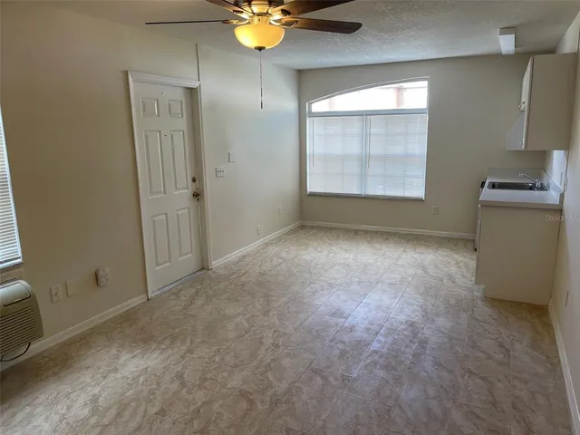 a view of a livingroom with a chandelier fan