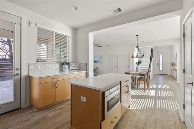 a open kitchen with a sink stove and wooden floor