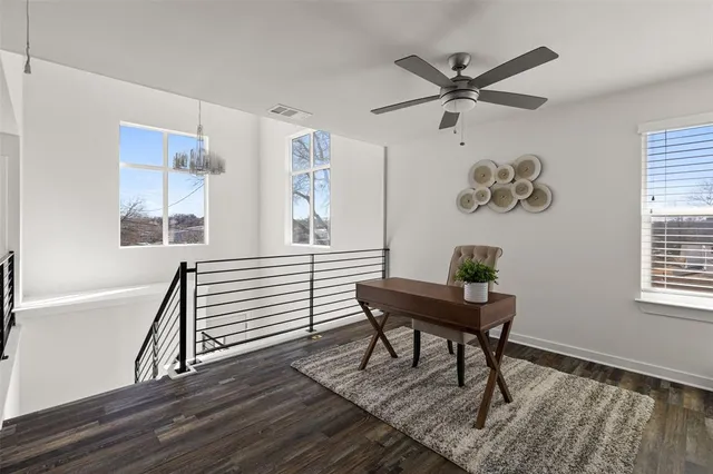 a workspace with wooden floor and a window